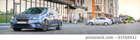 Panoramic view of new shiny expensive car parked on city street side. Panoramic view of new shiny expensive car parked on city street side. 83588932
