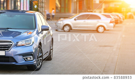 Closeup view of new shiny expensive car parked on city street side. 83588933