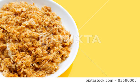 Dried shredded pork in white plate on yellow background. 83590003