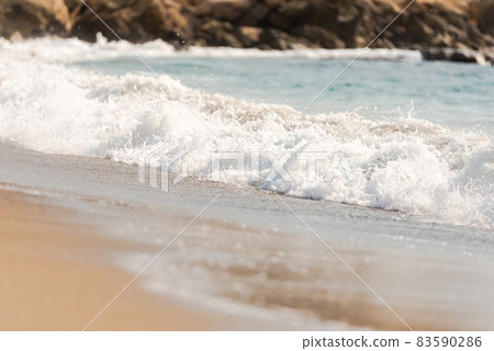 Mediterranean surf. Small waves roll on the shore. Sea foam on the beach. Mediterranean surf. Small waves roll on the shore. Sea foam on the beach. 83590286