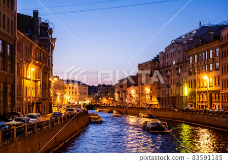 Beautiful illumination at dusk along a European canal Beautiful illumination at dusk along a European canal 83591185