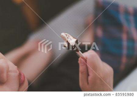 A woman eating ice cream 83591980