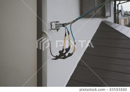 Pulling electric wires into a house Pulling electric wires into a house 83593880