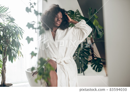 Cute young woman in a white bathrobe relaxing Cute young woman in a white bathrobe relaxing 83594030