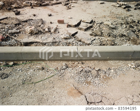 Road reconstruction. New curbstone installed and ready to be fixed with concrete, copyspace. Broken asphalt all about Road reconstruction. New curbstone installed and ready to be fixed with concrete, copyspace. Broken asphalt all about 83594195