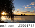 Sunset reflected on the surface of the lake 83594732