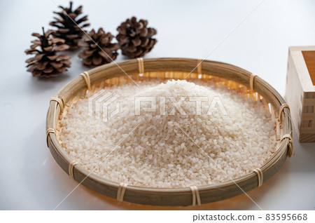 White rice and wooden box divided into colanders 83595668