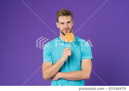 Taste of childhood. Man handsome macho eat big Taste of childhood. Man handsome macho eat big 83598476