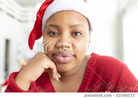 Happy african american plus size woman in santa hat making christmas video call on laptop Happy african american plus size woman in santa hat making christmas video call on laptop 83598553