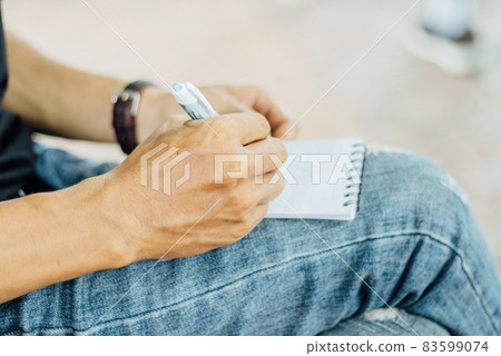 Take notes in a small notebook 83599074