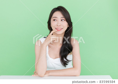 beauty concept, beautiful Korean Asian woman pointing at mouth and lips beauty concept, beautiful Korean Asian woman pointing at mouth and lips 83599384