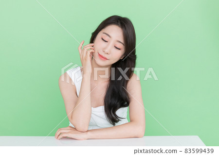 beauty concept, beautiful Korean Asian woman resting chin on hand beauty concept, beautiful Korean Asian woman resting chin on hand 83599439