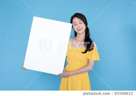 beautiful Korean Asian model with blank signboard, with empty copy space place for some text, advertising or slogan beautiful Korean Asian model with blank signboard, with empty copy space place for some text, advertising or slogan 83599633