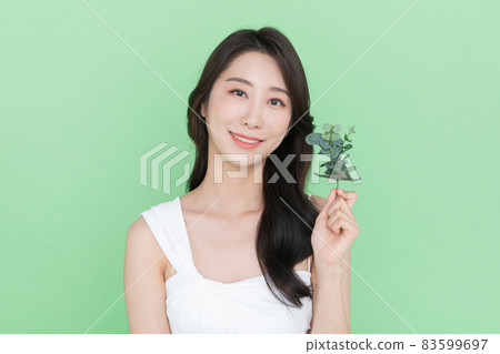 beauty concept, beautiful Korean Asian woman with green leaf beauty concept, beautiful Korean Asian woman with green leaf 83599697