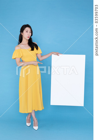 beautiful Korean Asian model with blank signboard, with empty copy space place for some text, advertising or slogan 83599703
