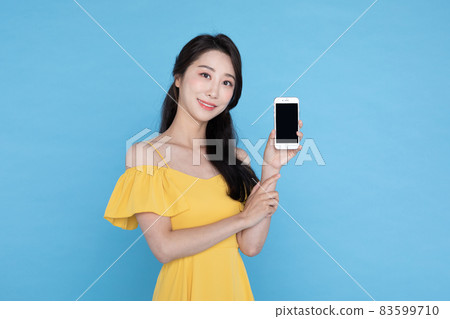 shopping event concept, smiling beautiful Korean Asian woman smiling at smart phone shopping event concept, smiling beautiful Korean Asian woman smiling at smart phone 83599710