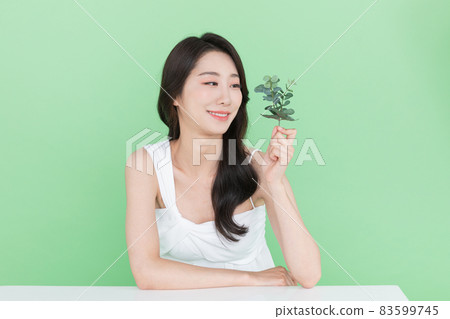 beauty concept, beautiful Korean Asian woman with green leaf beauty concept, beautiful Korean Asian woman with green leaf 83599745