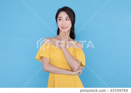 shopping event concept, smiling beautiful Korean Asian woman with hand near face 83599769
