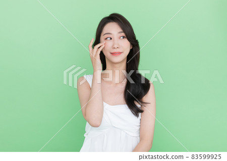 beauty concept, beautiful smiling Korean Asian woman touching eye beauty concept, beautiful smiling Korean Asian woman touching eye 83599925