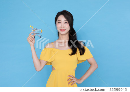 beautiful Korean Asian model with cart miniature, summer shopping event concept beautiful Korean Asian model with cart miniature, summer shopping event concept 83599943