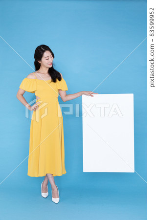 beautiful Korean Asian model with blank signboard, with empty copy space place for some text, advertising or slogan beautiful Korean Asian model with blank signboard, with empty copy space place for some text, advertising or slogan 83599952