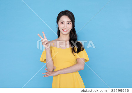 A beautiful Korean Asian woman doing the number two hand gesture A beautiful Korean Asian woman doing the number two hand gesture 83599956