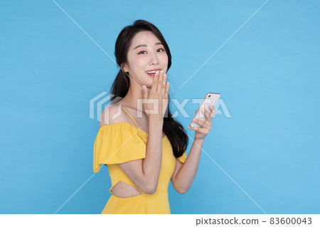 shopping event concept, smiling beautiful Korean Asian woman smiling at smart phone shopping event concept, smiling beautiful Korean Asian woman smiling at smart phone 83600043