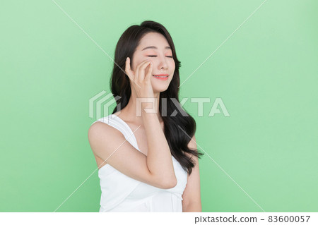 beauty concept, beautiful smiling Korean Asian woman touching eye beauty concept, beautiful smiling Korean Asian woman touching eye 83600057