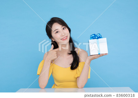shopping event concept, beautiful Korean Asian woman pointing at gift box shopping event concept, beautiful Korean Asian woman pointing at gift box 83600318