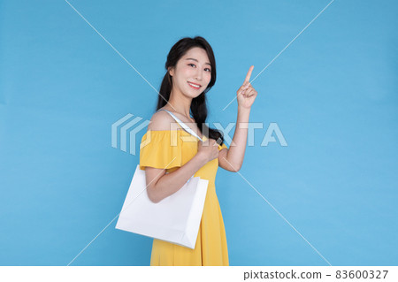 shopping event concept, beautiful Korean Asian woman with shopping bag in shoulder shopping event concept, beautiful Korean Asian woman with shopping bag in shoulder 83600327
