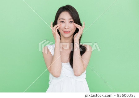 beauty concept, beautiful smiling Korean Asian woman touching eyes beauty concept, beautiful smiling Korean Asian woman touching eyes 83600353