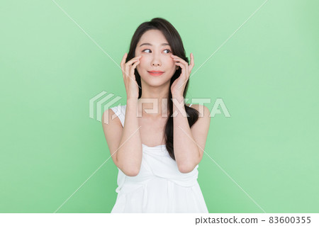 beauty concept, beautiful smiling Korean Asian woman with hand motion beauty concept, beautiful smiling Korean Asian woman with hand motion 83600355