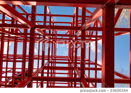 Image of red jungle gym and blue sky 83600384