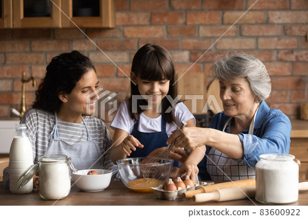 Happy Latin mom and grandma teaching girl to bake Happy Latin mom and grandma teaching girl to bake 83600922