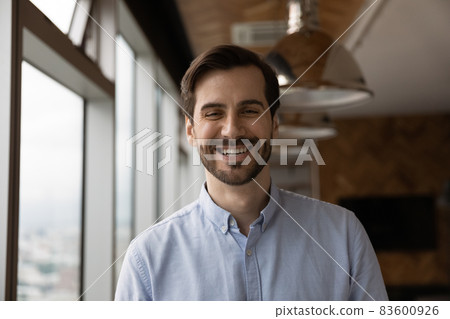 Happy candid young caucasian man looking at camera. Happy candid young caucasian man looking at camera. 83600926