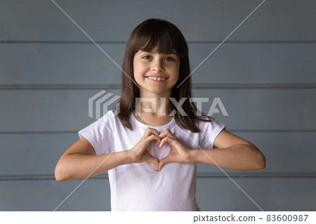 Happy joyful 7s girl making hand heart shape Happy joyful 7s girl making hand heart shape 83600987