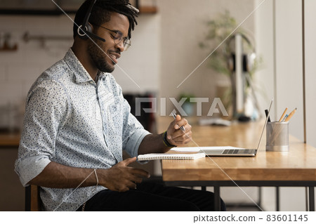 Smiling young african american man studying online. Smiling young african american man studying online. 83601145