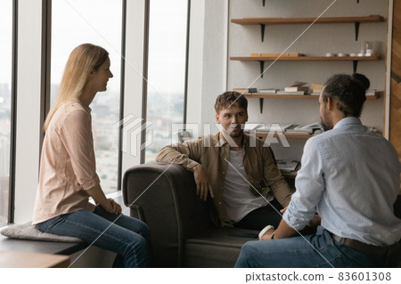 Happy young mixed race colleagues talking in office. Happy young mixed race colleagues talking in office. 83601308
