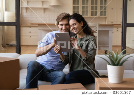 Couple use digital tablet buy online furniture for new house Couple use digital tablet buy online furniture for new house 83601567