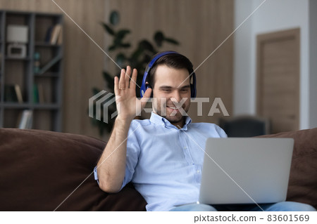 Happy friendly young man holding distant video call meeting. 83601569