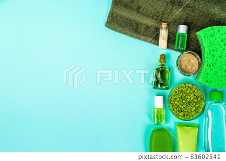 Spa set: soap, mask, oil, sea salt and towel on blue background Spa set: soap, mask, oil, sea salt and towel on blue background 83602541