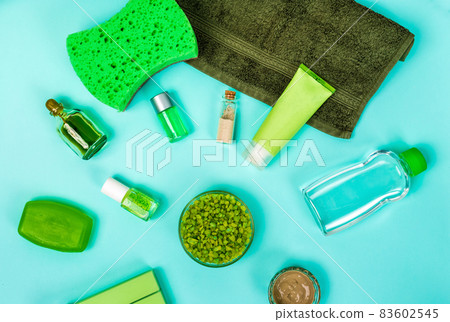 Spa set: soap, mask, oil, sea salt and towel on blue background 83602545