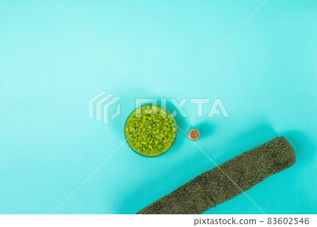 Spa set: oil, sea salt and towel on blue background 83602546