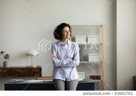 Happy dreamy older woman visualizing future at home office. 83602761