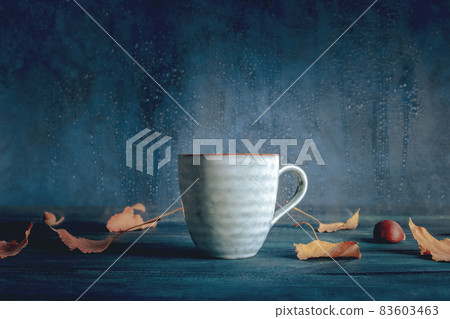 Autumn still life with a cup of tea, autumn leaves, and rain Autumn still life with a cup of tea, autumn leaves, and rain 83603463