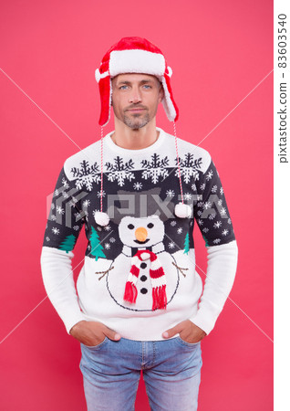 man wearing funny knitted sweater and hat for celebrating christmas party, merry christmas 83603540