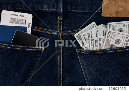 Dollars, smart, passport and plane ticket in your pocket jeans. 83603935