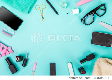 Top view of manicure and pedicure equipment on blue background Top view of manicure and pedicure equipment on blue background 83603995