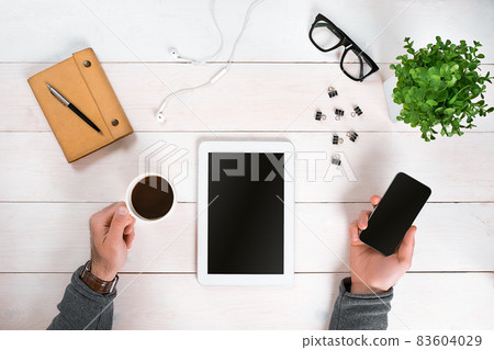 Directly above view of human hands with digital tablet. Directly above view of human hands with digital tablet. 83604029