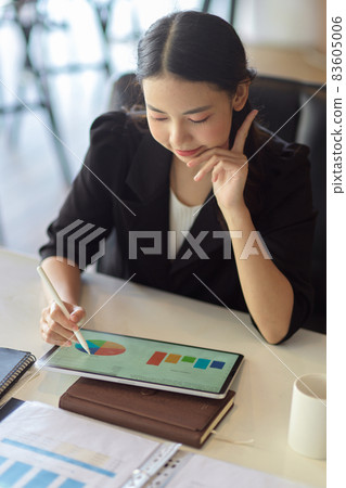 Accountant working and making pie chart graphic report via tablet Accountant working and making pie chart graphic report via tablet 83605006